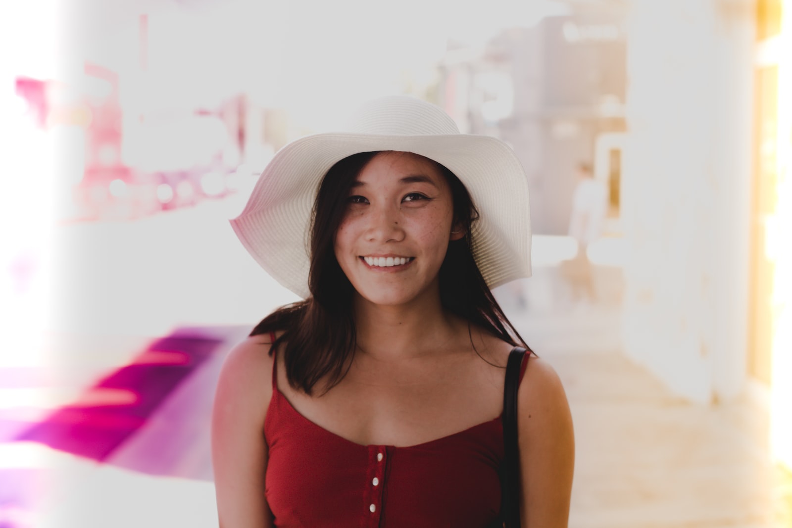 smiling woman wearing white sun hat